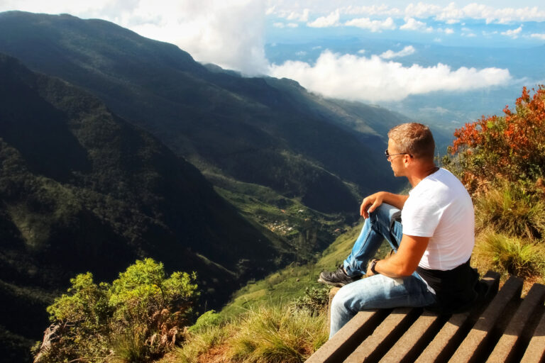 Man,Relaxes,On,The,Edge,Of,The,Cliff,