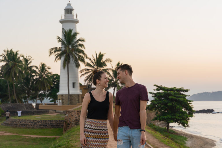Young,Couple,Walking,Near,The,Sea,On,Sunset
